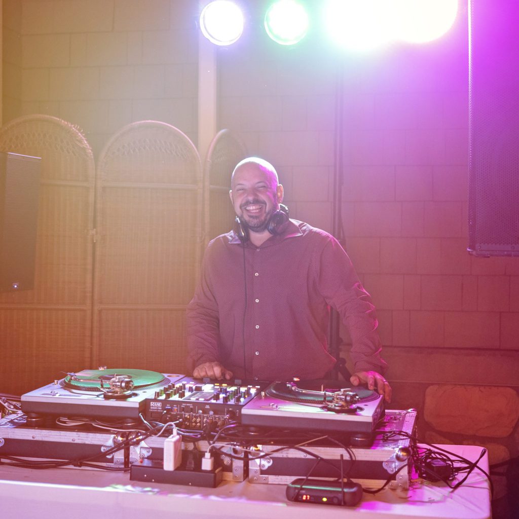 How To Create A Wedding Day Timeline in 5 Easy Steps: Dj smiling during the wedding reception.